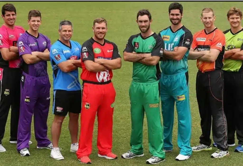 8 players standing in style as Big Bash Captains, green grass in the background