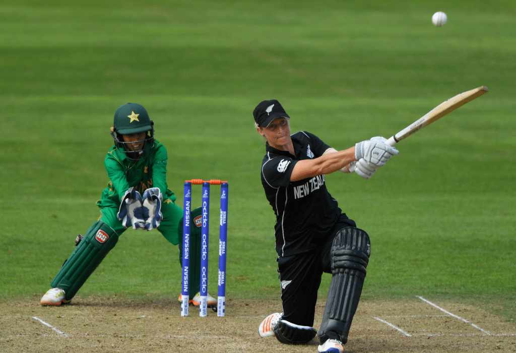 Female New Zealand cricketer playing the shot while Pakistani wicket keeper trying to catch it behind the wickets